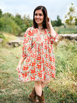 woman standing in field wearing Coral and Blue Fall Floral Mini Dress with Baby Doll Silouette with 3/4 sleeves