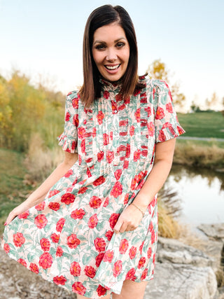 The Sabina Dress – Blush Floral High Neck Mini Dress with Ruffles and Pleating