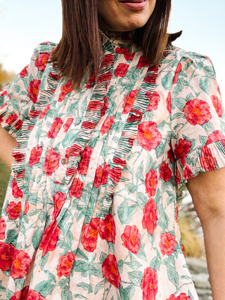 The Sabina Dress – Blush Floral High Neck Mini Dress with Ruffles and Pleating