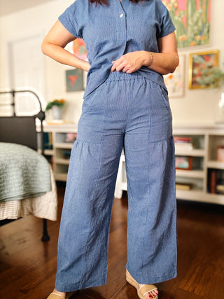 Person wearing a blue set outfit in an indoor setting