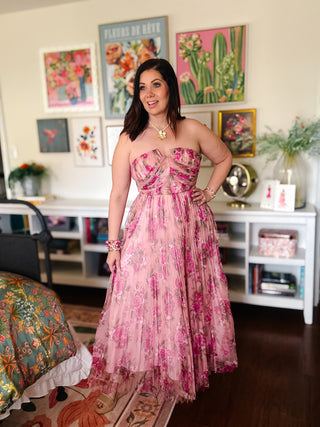 Strapless floral maxi dress with structured bodice and pleated skirt. Perfect wedding guest dress with romantic pink print and flattering fit.
