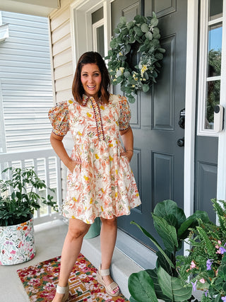 Women’s fall floral mini dress with puff sleeves, contrast floral collar and placket, button details, flowy skirt and pockets.