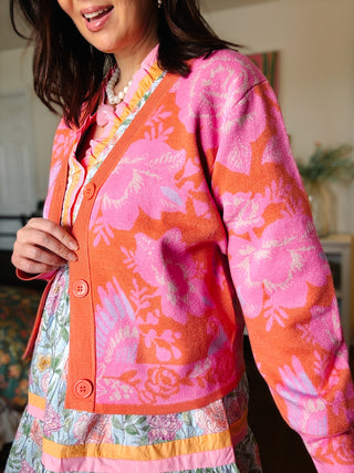 colorful floral cardigan sweater layered over a feminine boutique dress