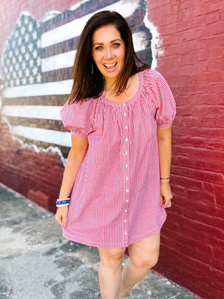 Woman wearing a red gingham puff sleeve mini dress with button front detail and relaxed fit, perfect for Fourth of July celebrations, summer BBQs, patriotic events, and casual Americana style.