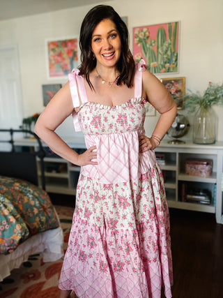 pink floral smocked midi dress with bow tie straps and tiered skirt